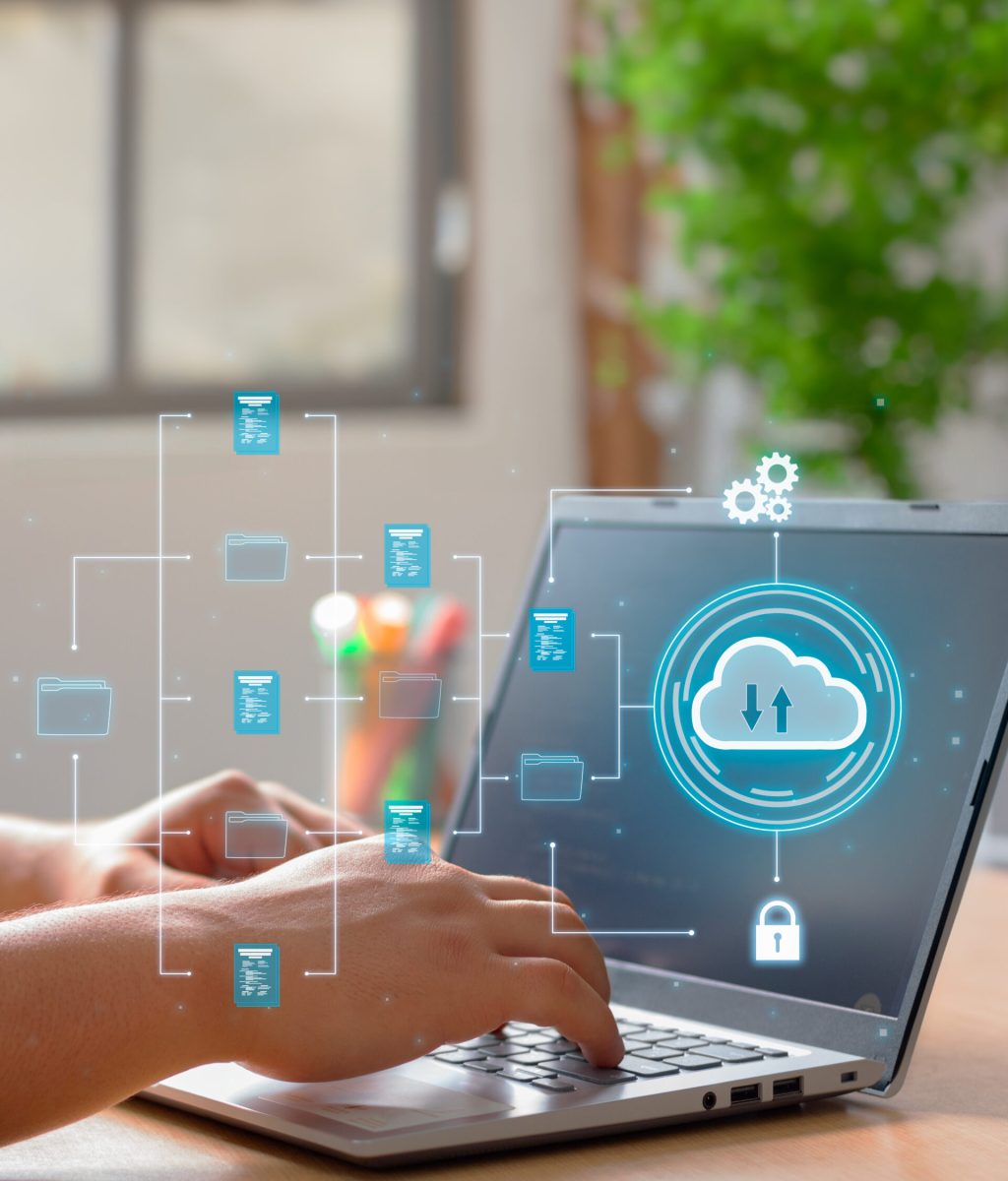 Vertical Photo of A man utilizes cloud computing technology on his laptop for data transmission, storage, backup, and retrieval